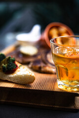 glass of whiskey.. beef steak on wooden table, a  Close up.