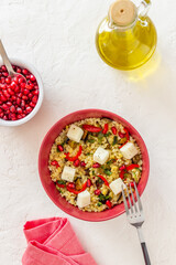 Bulgur with cheese, pepper, eggplant and pomegranate. Healthy eating. Vegetarian food. Diet.