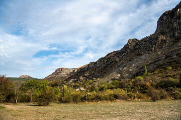 Obraz premium panoramic view of yellow autumn mountains against a background of blue haze and storm clouds