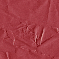 Red vintage and old looking crumpled paper background. Retro cardboard texture. Grunge paper for drawing. Ancient book page. Present wrapping.