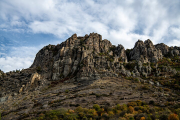 panoramic view of yellow autumn mountains against a background of blue haze and storm clouds