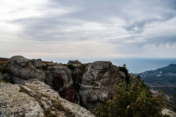 panoramic view of yellow autumn mountains against a background of blue haze and storm clouds