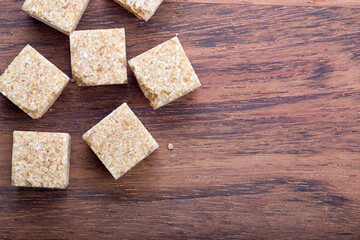 cane sugar cubes on brown wood background