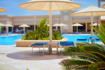 a view on all inclusive tropical resort and swimming pool with lounge zone