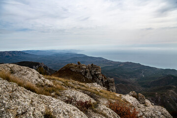panoramic view of yellow autumn mountains against a background of blue haze and storm clouds filmed from a drone