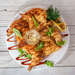 baked grilled chicken with garlic sauce, herbs and lemon