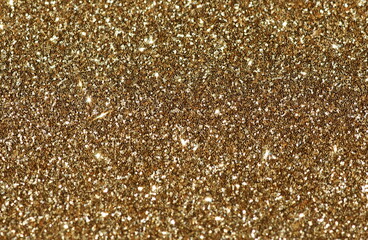 Christmas gold sparkle background . Glitter texture .  Festive, Xmas, holiday, party  abstract backdrop with copy space.