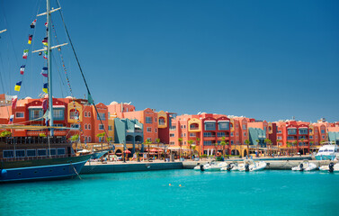panoramic seascape on colorful Marina promenade street from Red Sea with moored motor yachts....
