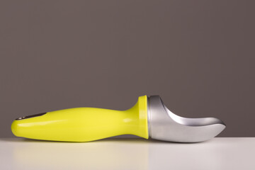 Single piece ice cream scoop with a green handle, with plenty of copyspace for designers