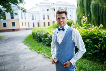 young guy businessman groom on their wedding day, stylish clothing, a walk in the park