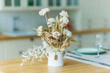A Stylish table setting with dried flowers.