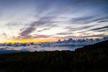 Obraz premium panoramic view of yellow autumn mountains against a background of blue haze and storm clouds filmed from a drone