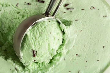 Ball of mint choc chip ice cream being scooped up