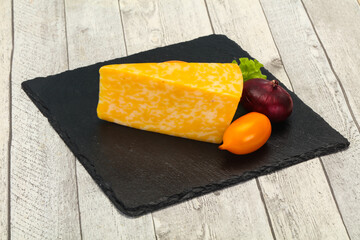 Marble cheese  triangle over wooden