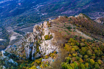 yellow autumn mountains against a background of blue haze and storm clouds
