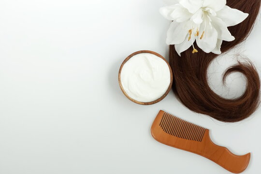 female hair, hair mask yogurt and bamboo comb on white background top view, flat lay. copy space. Self care, hair treatment  concept.