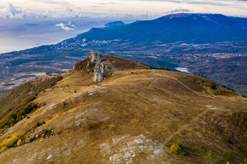 yellow autumn mountains against a background of blue haze and storm clouds