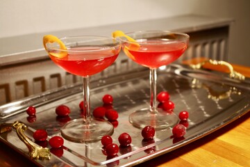 Cosmopolitan cocktails garnished with cranberries