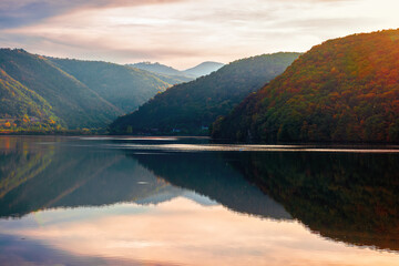 gilau lake of cluj country in evening light. beautiful landscape of romania in autumn. reflection...