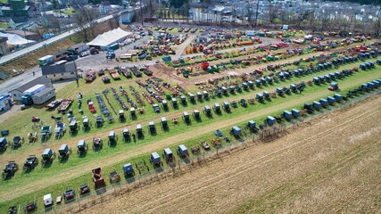 Aerial View of an Amish Mud Sale with Lots of Buggies and Farm Equipment