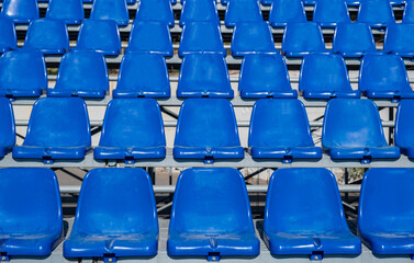 Stadium seats background. Rows of blue plastic empty chairs