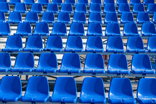 Stadium seats background. Rows of blue plastic empty chairs