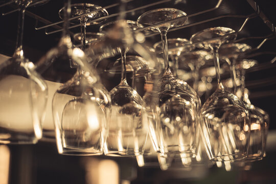 Empty wine glasses suspended in a pub