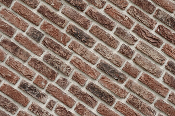 Texture of a beautiful decorative brick wall with a diagonal laying, brick facade of the house. Place for text