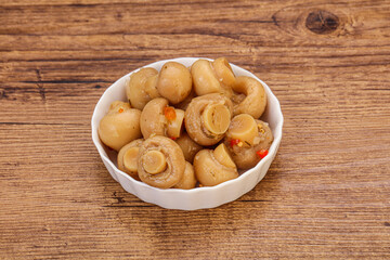 Pickled champignons in the bowl