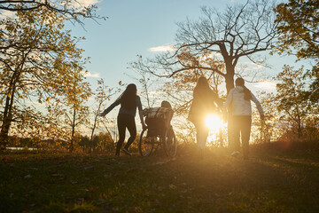 Disabled teen jumping into pile of leaves with a group of his friends.