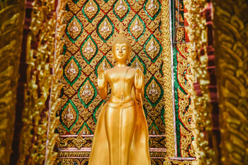 Fototapeta na wymiar Buddha statue with beautiful details of Thai fine arts background at Buddhist temple. 