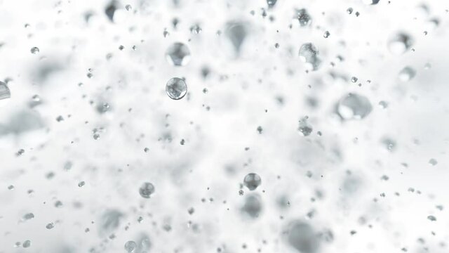 Explosion of water droplets into the camera in slow motion on an isolated white background.