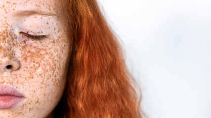 Portrait of a red-haired girl with freckles