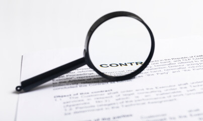 Magnifying Glass over contract, inspection of documents agreement concept