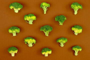 Flat lay composition with broccoli raw on color background brown