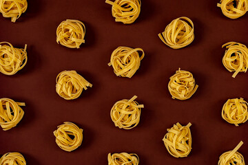 Flat lay composition with noodles raw on color background brown.