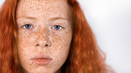 Portrait of a red-haired girl with freckles