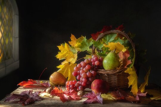 Autumn still life with maple leaves and fruits