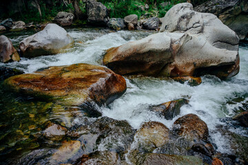 Nature background with cascades of mountain creek close-up. Scenic landscape with beautiful...