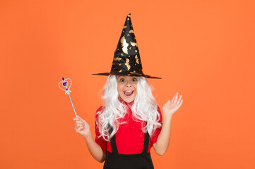 happy girl wear witch hat holding magic wand to create enchantment on halloween, happy halloween wonder