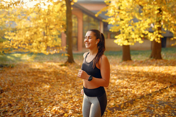 Beautiful girl training. Sports girl in a sportswear. Brunette in a black top