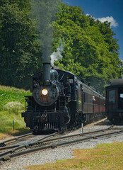 Naklejka premium Restored Antique Steam Locomotive with Passenger Cars