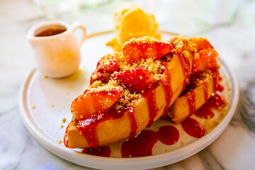sweet dessert in white dish. Contain honey toast and ice-cream and strawberry 