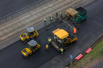 On city streets, repair work to replace the asphalt pavement with the use of large construction...