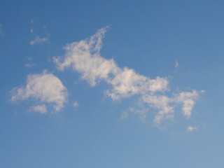 White clouds in blue sky making the shape of Great Britain and Northern Ireland