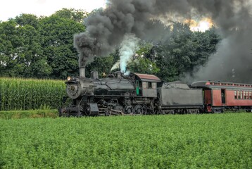 Fototapeta na wymiar Restored Antique Steam Locomotive with Passenger Cars