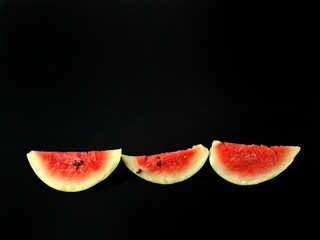 Pieces of watermelon on black background, tropical fruit