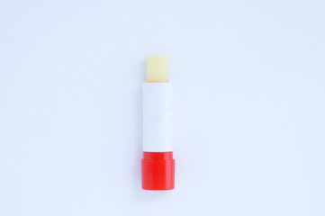 Hygienic lipstick balm in red tube on a white background.