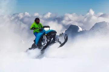 Gordijnen Adventurous Man Riding a Snowmobile in white snow. Epic Action Extreme Sport Composite. Background Mountains from British Columbia, Canada. © edb3_16