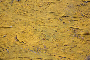 A painted fragment of a slab of pressed wood waste. Texture, yellow and gray background